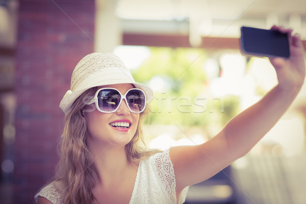 Stock photo: Pretty hipster woman taking a selfie