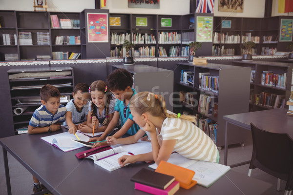 Stock photo: Attentive schoolkid using digital tablet in library
