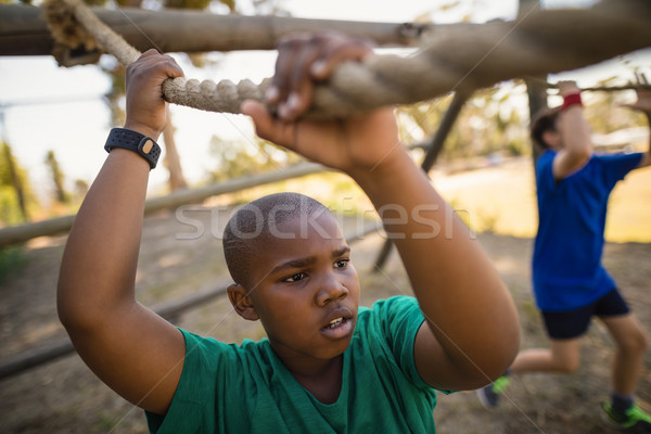 Boy crossing the rope during obstacle course Stock photo © wavebreak_media