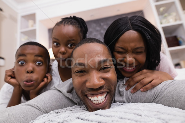 Portrait of happy family lying on bed Stock photo © wavebreak_media