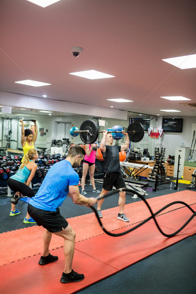 Fit people working out in weights room Stock photo © wavebreak_media