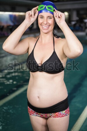 Beautiful woman standing at poolside Stock photo © wavebreak_media