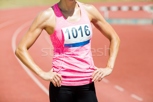 Mid section of female athlete standing with hands on hips Stock photo © wavebreak_media