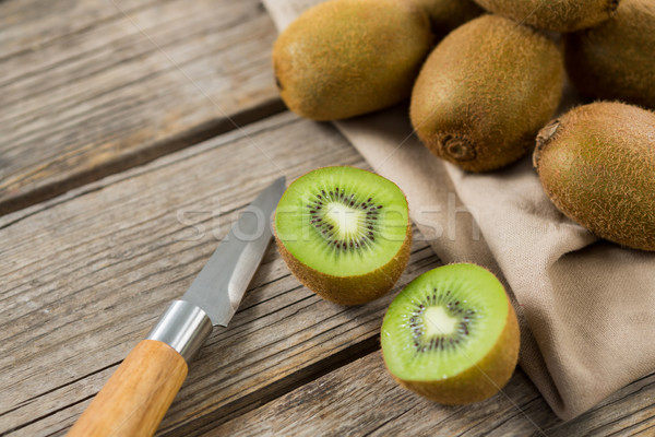 Kiwis with knife on wooden table Stock photo © wavebreak_media