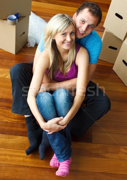 Stock photo: Happy young couple sitting on floor