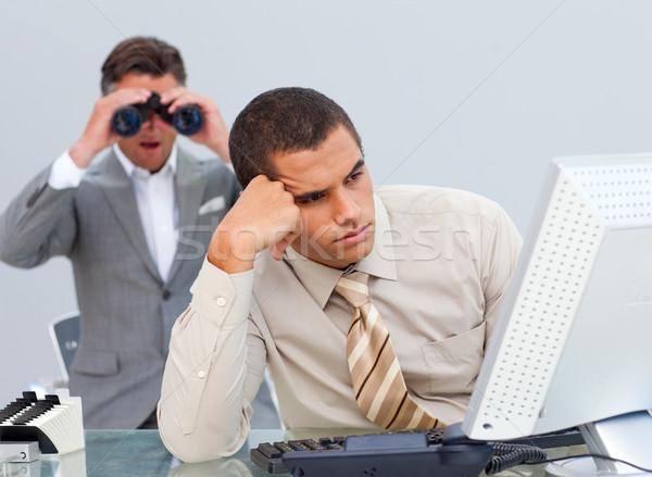 Young businessman getting bored and his manager looking through binoculars Stock photo © wavebreak_media