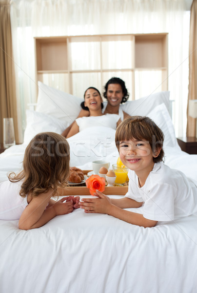 Happy children bringing a breakfast to their parents  Stock photo © wavebreak_media