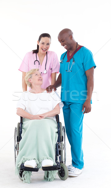 Nurse and doctor taking care of a patient in a wheel chair Stock photo © wavebreak_media