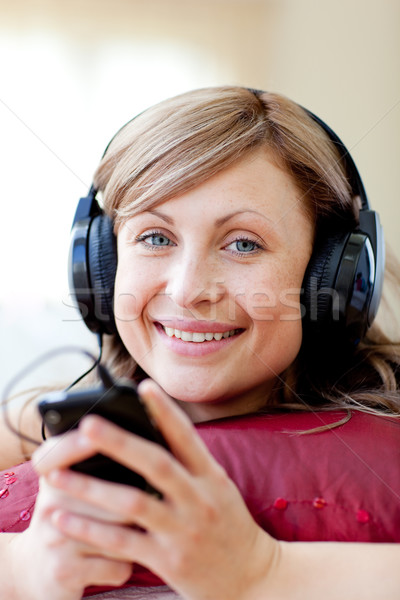 Delighted woman is listening the music in the living-room  Stock photo © wavebreak_media