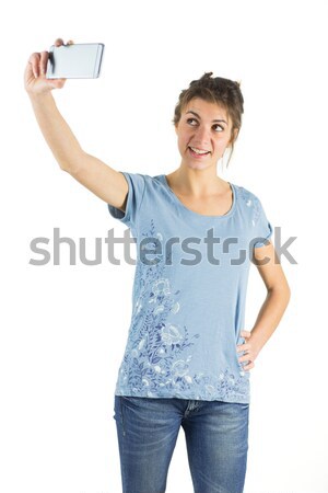 Pretty female holding a chocolate bar and an apple while standing against a white background Stock photo © wavebreak_media