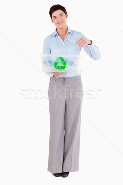 Woman putting a plastic bottle in a recycling box against a white background Stock photo © wavebreak_media
