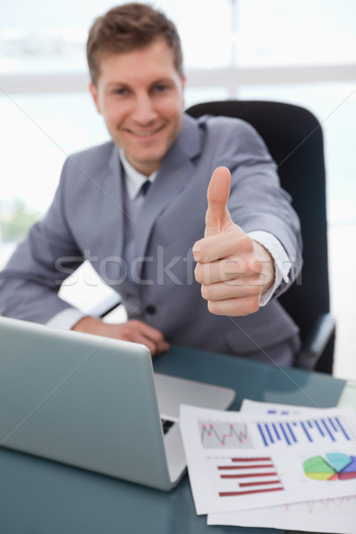Thumb up given by sitting businessman Stock photo © wavebreak_media