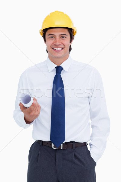 Smiling male architect with helmet and plans against a white background Stock photo © wavebreak_media