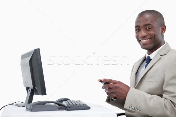 Mosolyog üzletember küldés szöveges üzenet fehér számítógép Stock fotó © wavebreak_media