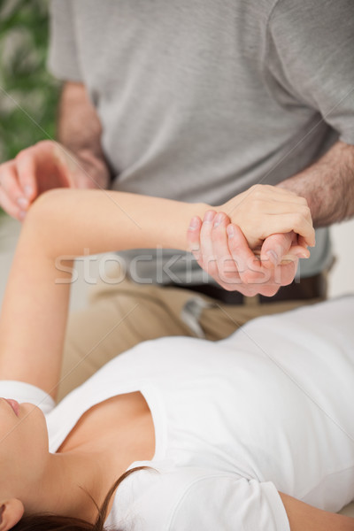 Physiotherapist moving the arm of a woman in a room Stock photo © wavebreak_media