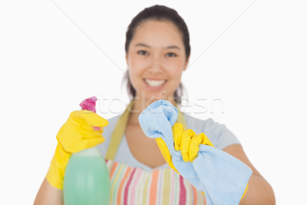 Happy woman in apron wiping with cloth in front of her  Stock photo © wavebreak_media