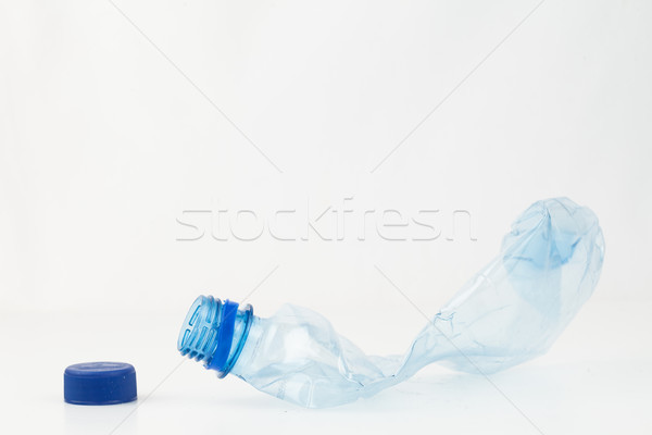 Empty plastic bottle crushed and blue cap to recycle Stock photo © wavebreak_media