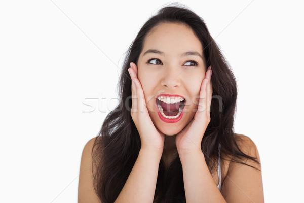 Smiling woman yelling on white background Stock photo © wavebreak_media