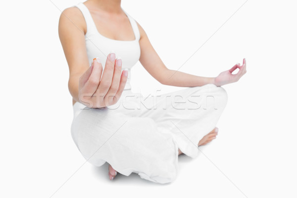 Midsection of young woman sitting in lotus position Stock photo © wavebreak_media