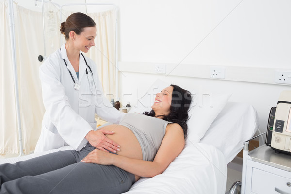 Female doctor attending pregnant woman Stock photo © wavebreak_media