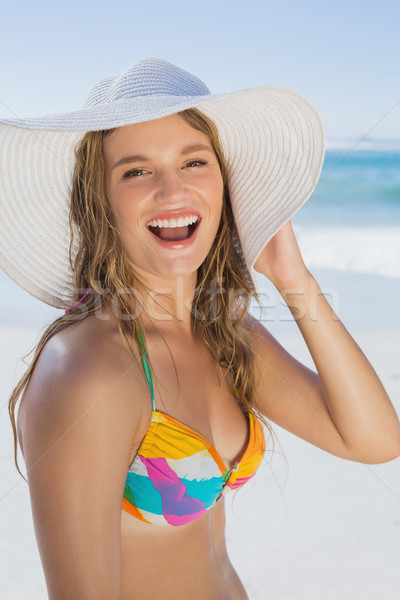 Stock photo: Beautiful girl in bikini and straw hat smiling at camera on beac