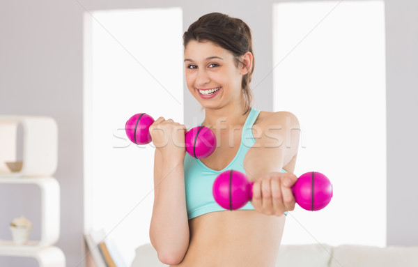 Fit brunette holding pink dumbbells  Stock photo © wavebreak_media