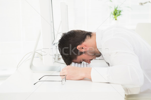 Exhausted businessman napping on keyboard Stock photo © wavebreak_media