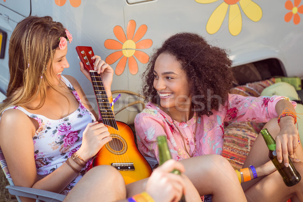 Happy hipsters relaxing on campsite Stock photo © wavebreak_media
