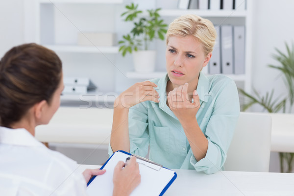 Stock photo: Unhappy patient speaking with doctor 