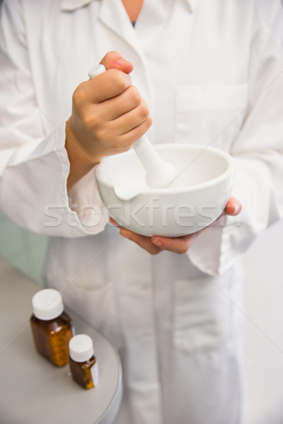 Junior pharmacist mixing a medicine Stock photo © wavebreak_media