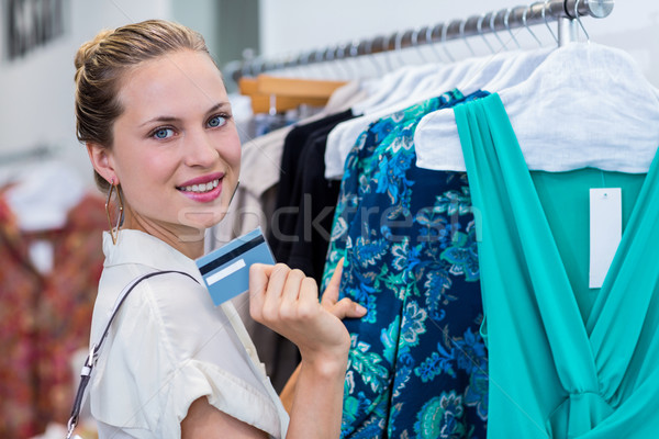 Smiling woman showing credit card to camera Stock photo © wavebreak_media