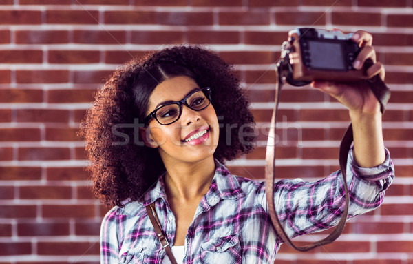 Attractive hipster taking selfies with camera Stock photo © wavebreak_media