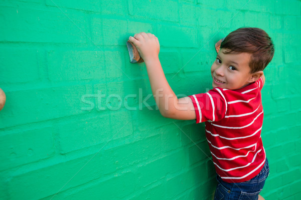 Portrait of smiling boy climbing wall at playground Stock photo © wavebreak_media