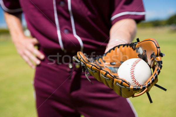 Mid section of baseball pitcher showing ball in glove Stock photo © wavebreak_media