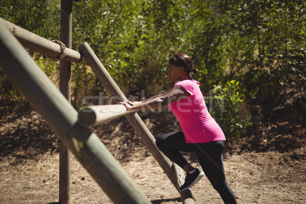 Woman exercising on outdoor equipment during obstacle course Stock photo © wavebreak_media