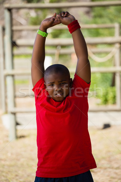 Boy performing stretching exercise during obstacle course training Stock photo © wavebreak_media