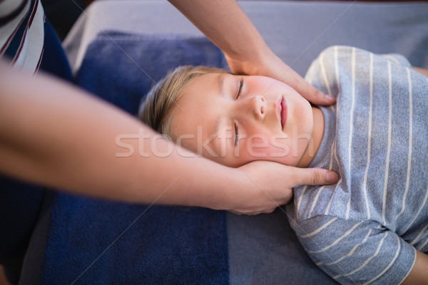 High angle view of female therapist giving neck massage to boy Stock photo © wavebreak_media
