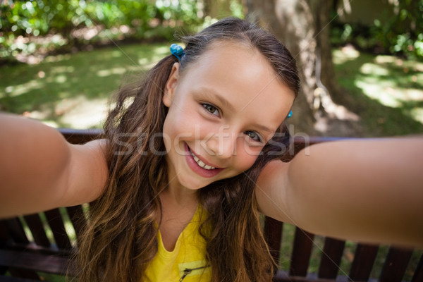Portrait of playful girl sitting on bench Stock photo © wavebreak_media