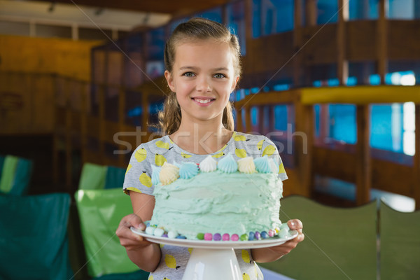 Portrait of smiling girl holding cake Stock photo © wavebreak_media