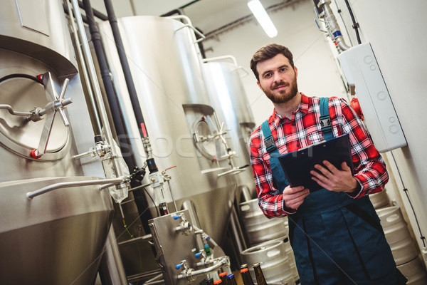 Portrait of manufacturer holding writing pad in brewery Stock photo © wavebreak_media