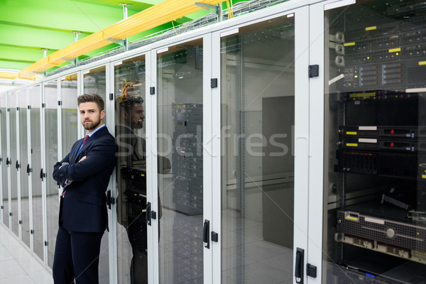 Technician standing with arms crossed in a server room Stock photo © wavebreak_media