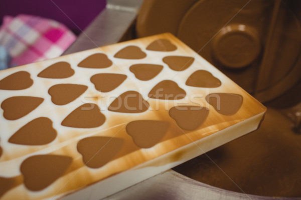 Close-up of mould filled with melted chocolate on blending machine Stock photo © wavebreak_media
