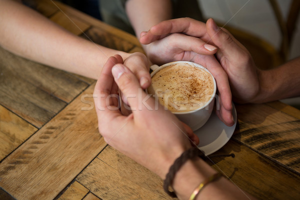 Couple holding hands and coffee cup in cafeteria Stock photo © wavebreak_media