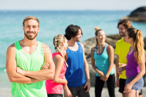 Smiling friends standing on shore Stock photo © wavebreak_media