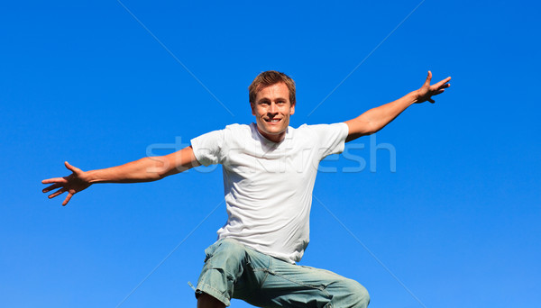 Young man jumping in the air Stock photo © wavebreak_media