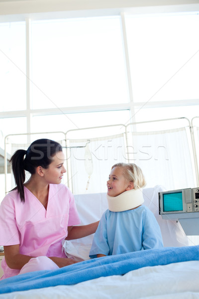 Little girl with a neck brace smiling at the nurse Stock photo © wavebreak_media