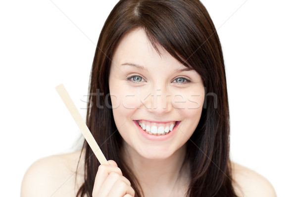 Portrait of a glowing young woman holding a nail file against white background Stock photo © wavebreak_media