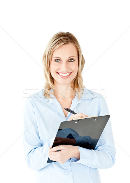 Glowing young businesswoman taking notes on her clipboard against white background Stock photo © wavebreak_media