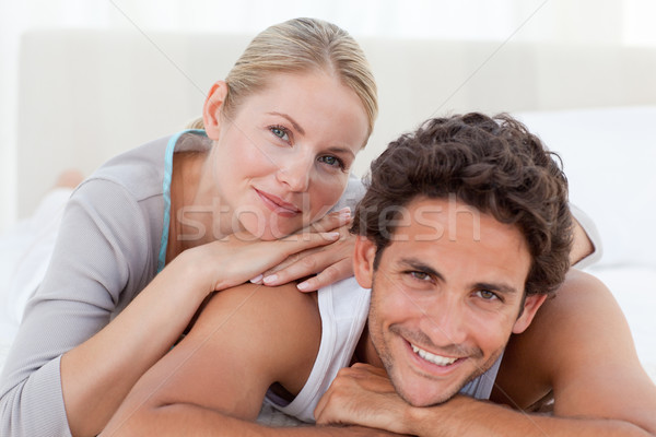 Beautiful couple lying down on their bed at home Stock photo © wavebreak_media