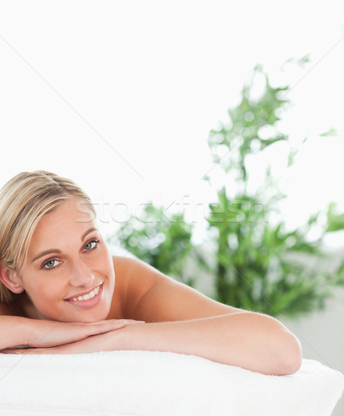 Close up of a blonde smiling woman lying on a lounger in a wellness center Stock photo © wavebreak_media